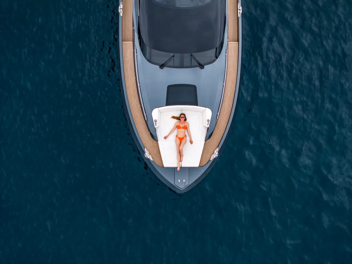 Sunbather on the bow sun bed, seen from above