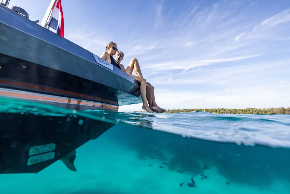 Owners on the swim platform above clear turquoise water