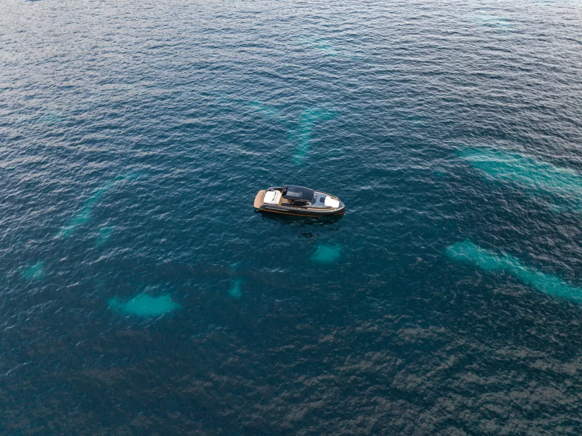 Bekkers AZUR 45 at anchor over turquoise reef water, seen from above