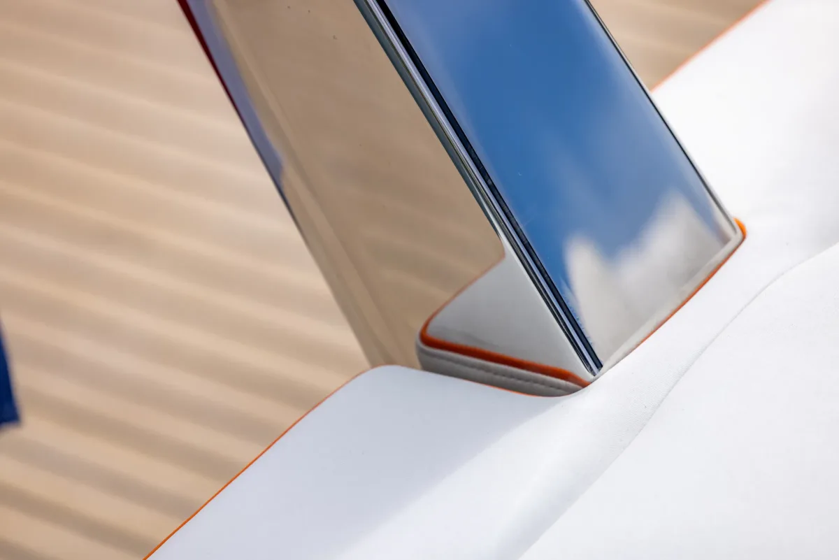 Polished stainless steel flagpole base with orange piping