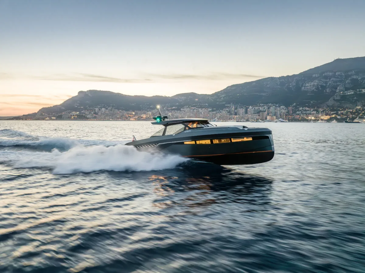 Bekkers AZUR 45HT aluminium hardtop weekender at speed off Monaco at dusk